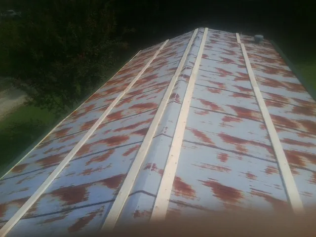 Rusted metal roof panels with new wood purlins before replacement — Storm Damage Roof Repair in Bayville by Roofing Brothers